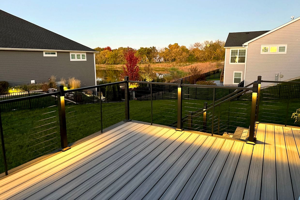 Contemporary Cable Railing System Installed On A Raised Composite Deck During Sunset.