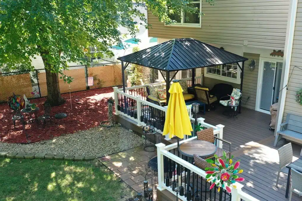 Deck privacy ideas featuring a gazebo and colorful garden elements.