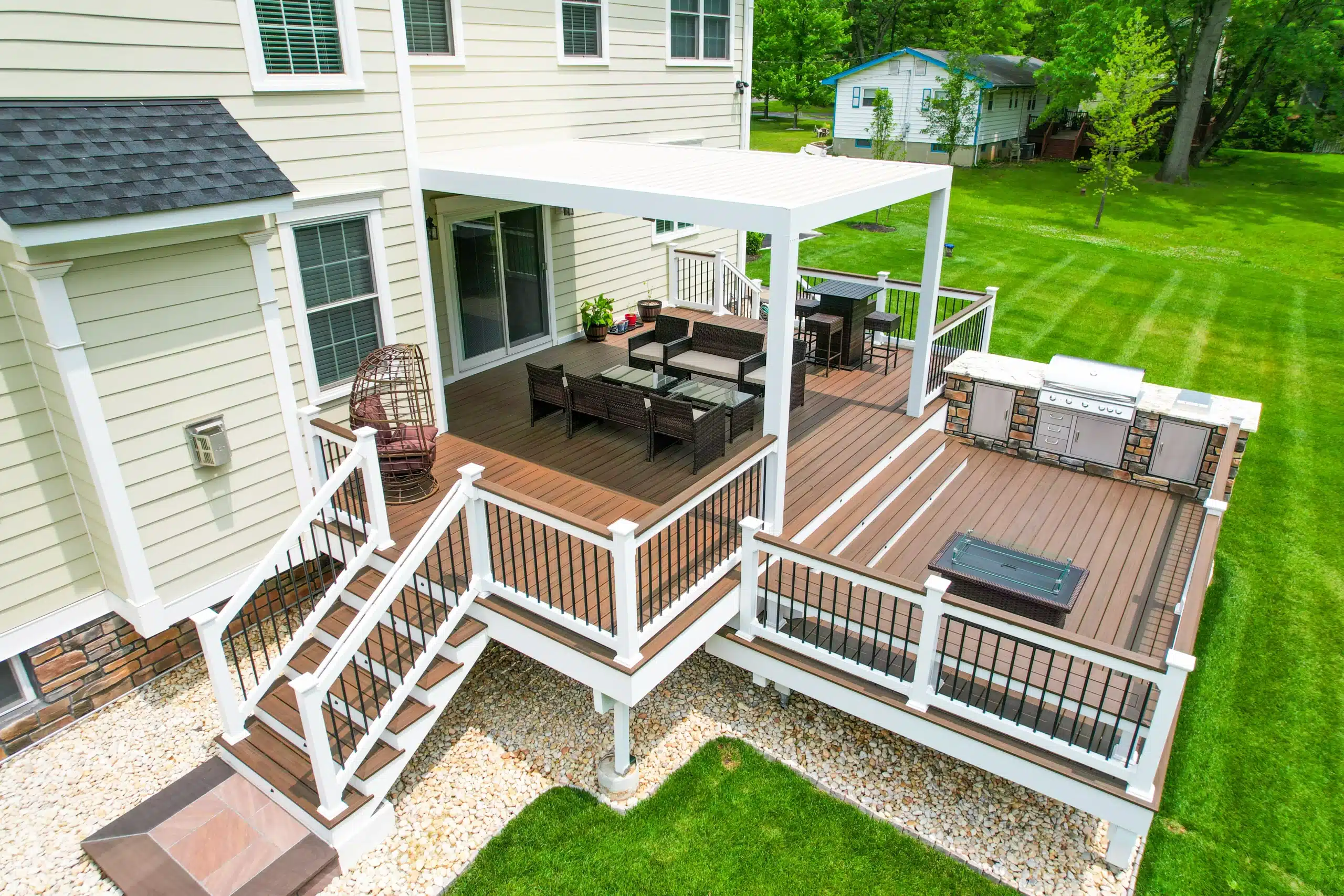 pergola louvers 1 A Spacious Backyard With A Pergola, Deck, And Outdoor Kitchen, Featuring Pergola Louvers For Shade.