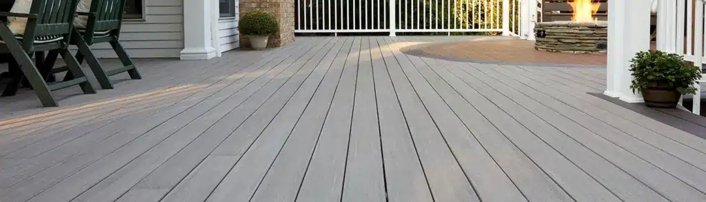 A stylish composite deck with smooth, uniform planks, showcasing the durability and aesthetic appeal of composite vs wood decks.