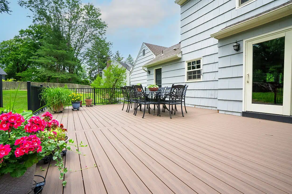 composite vs wood decks 3 A Beautiful Composite Deck With A Seating Area, Showcasing The Appeal Of Composite Vs Wood Decks For Backyard Spaces.