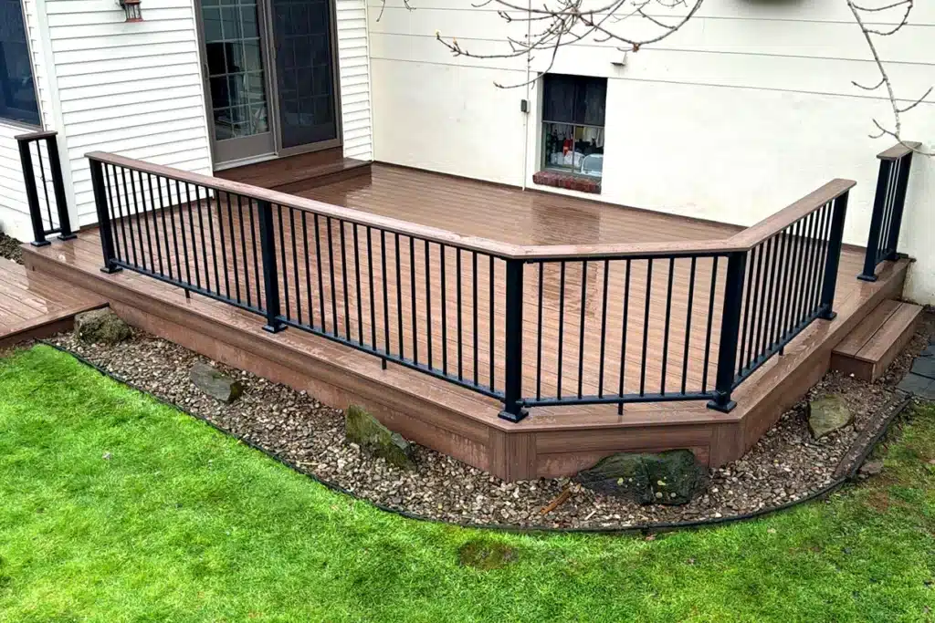 A ground-level deck with black railings, showcasing a clean and well-maintained surface, perfect for deck maintenance NJ.