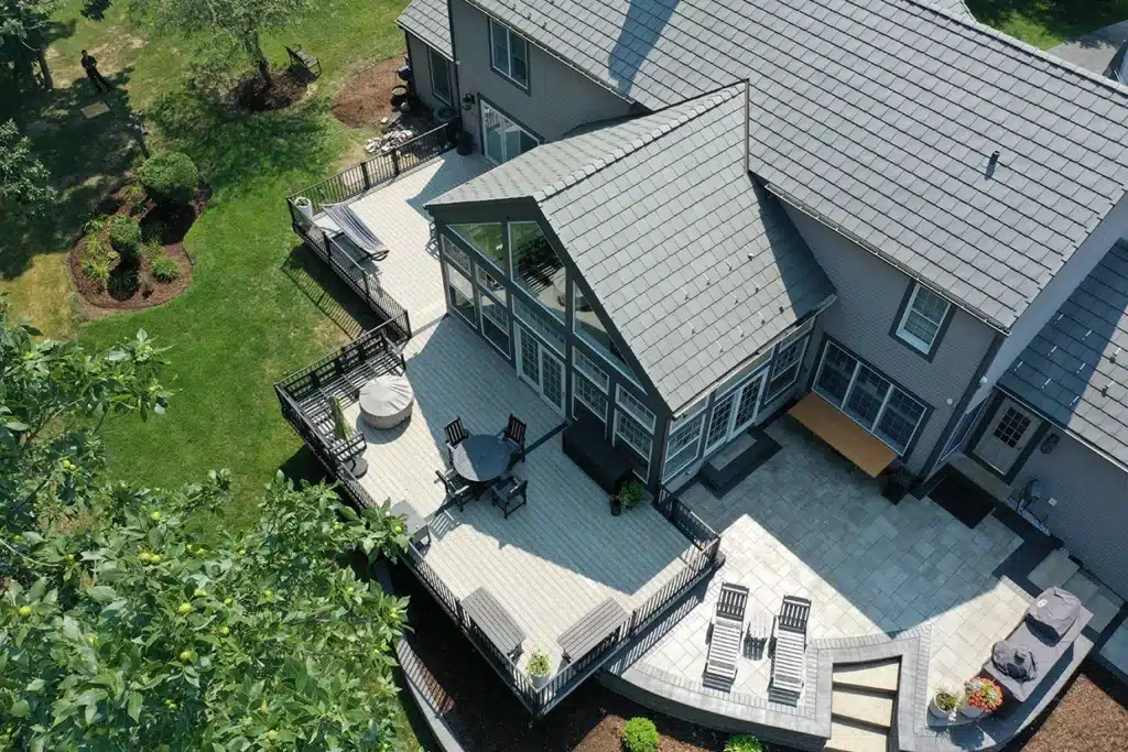 A spacious deck with seating and a landscaped backyard, perfect for NJ Patio Installation.