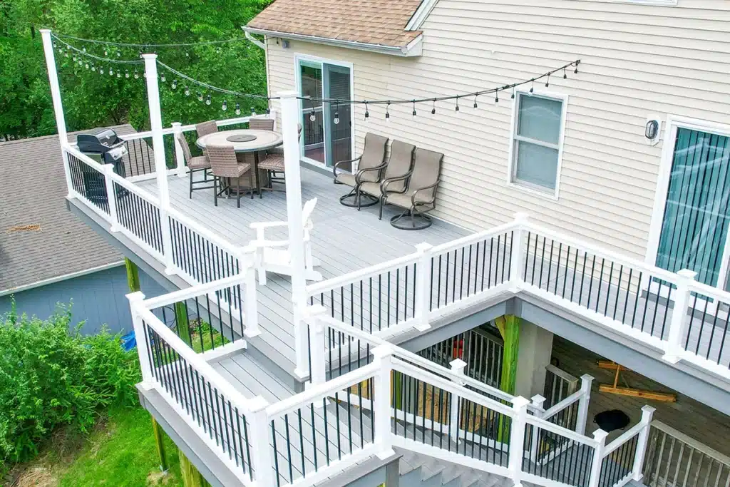 A spacious open deck with stylish railings and lights, ideal for comparing covered vs open deck designs.