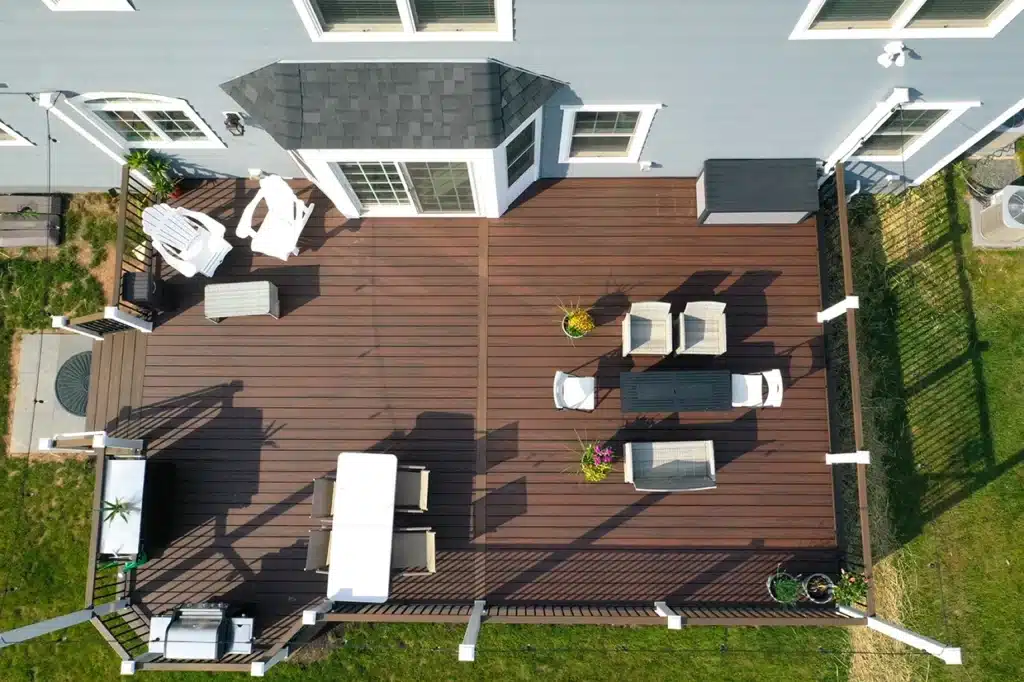 Spacious deck with seating area and dining set featuring deck resurfacing colors NJ