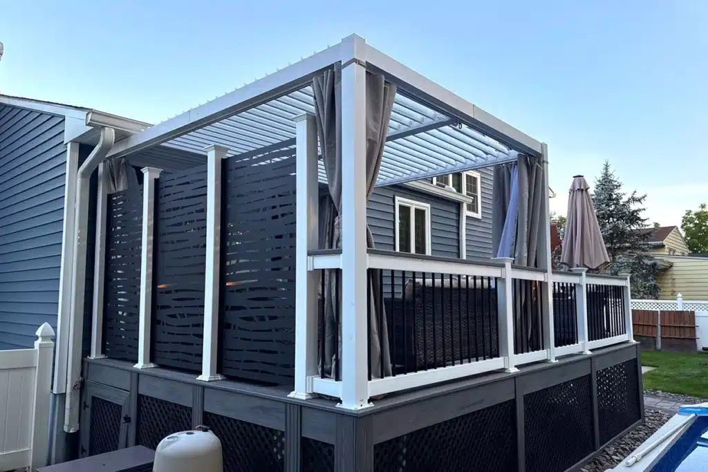 A modern pergola with a louvered roof, side screens, and curtains for added privacy and shade.