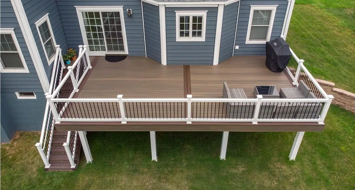 Composite Deck In Robbinsville, New Jersey With Vinyl Railings, Outdoor Seating, And A Wide Backyard View.